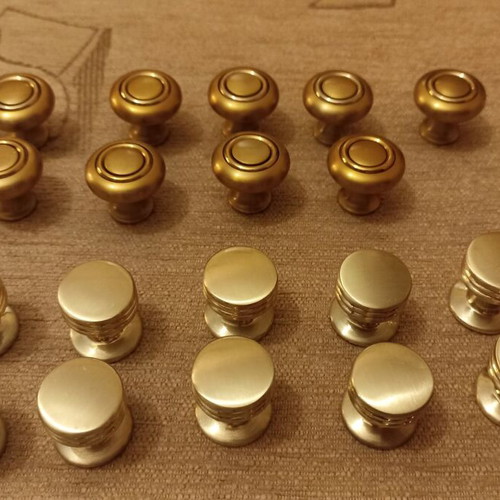 Handles and knobs for cabinets and drawers used, 24 pieces gold and silver