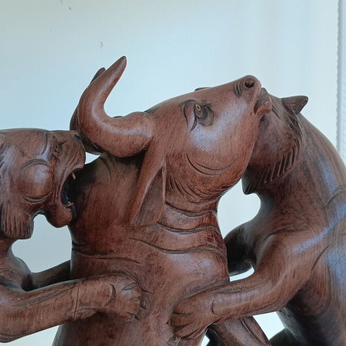 Hunting scene with buffalo and predators wood carving