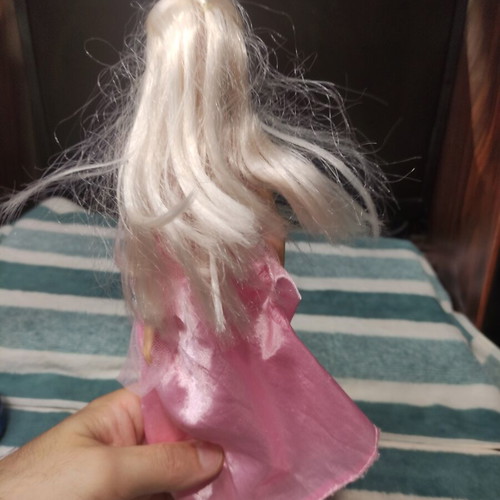 Barbie doll used with dress tears