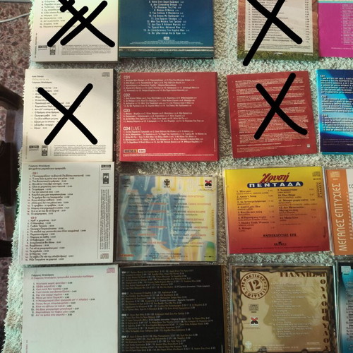 Collection of 22 Greek and international music CDs in 13 cases