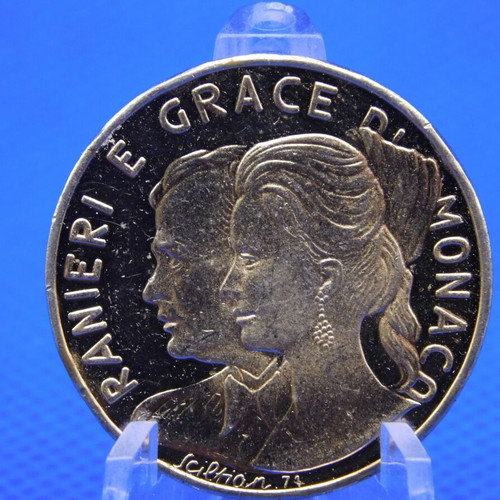 Commemorative metal token with Prince Rainier and Grace Kelly of Monaco