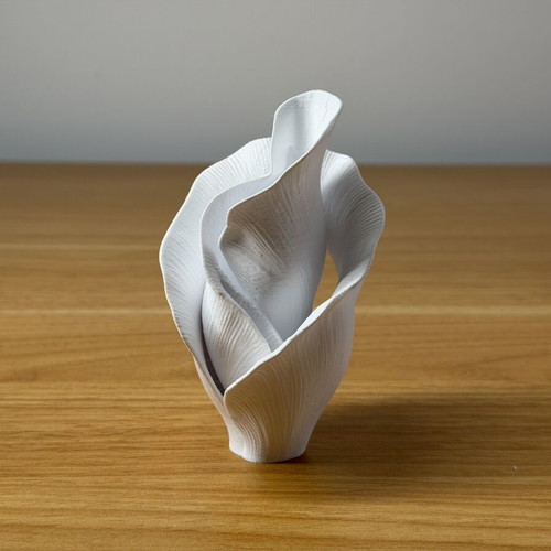 Decorative vase sculpture with ethereal flower design