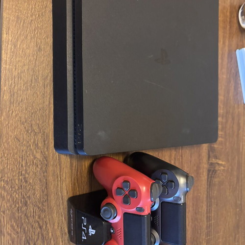 Sony PlayStation 4 Slim 500GB console with controllers