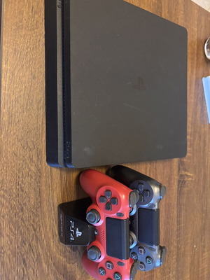 Sony PlayStation 4 Slim 500GB console with controllers