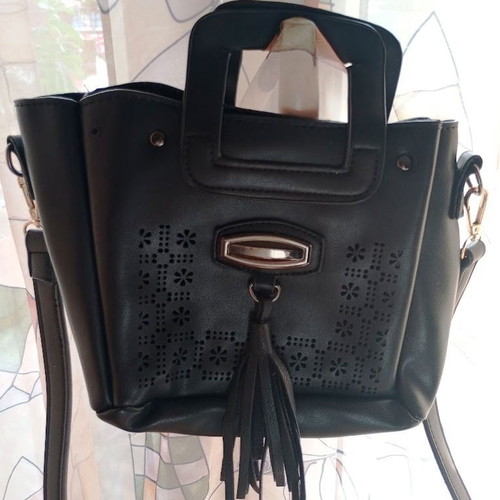 Black Women's Shoulder Bag like new with laser-cut patterns and tassels