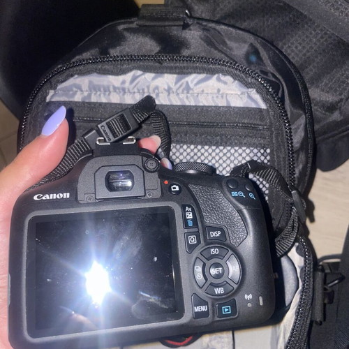 Canon EOS 1200D camera kit with lenses, memory card, battery, charger, and carrying bag