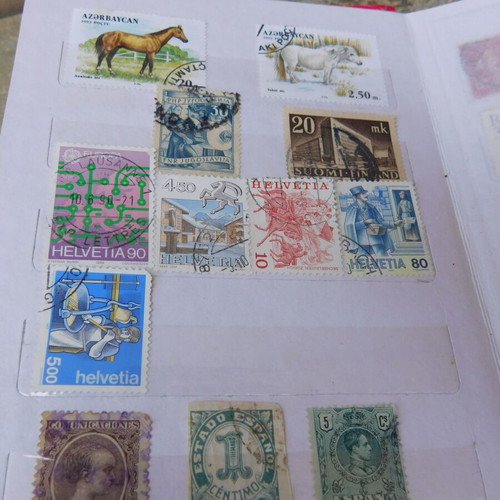 Red album with worldwide collectible stamps