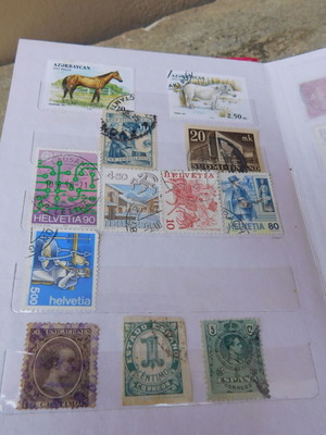 Red album with worldwide collectible stamps