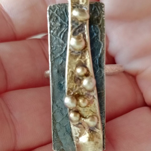 Statement two-tone ring used with layers, silver and gold colors