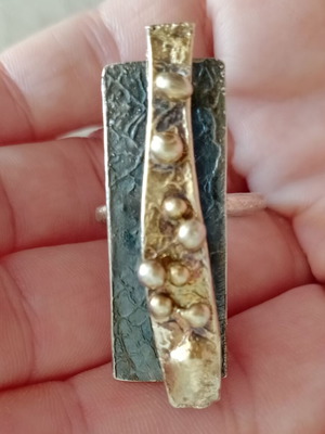 Statement two-tone ring used with layers, silver and gold colors