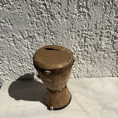 Handmade wooden drum used, African style with leather membrane and shells