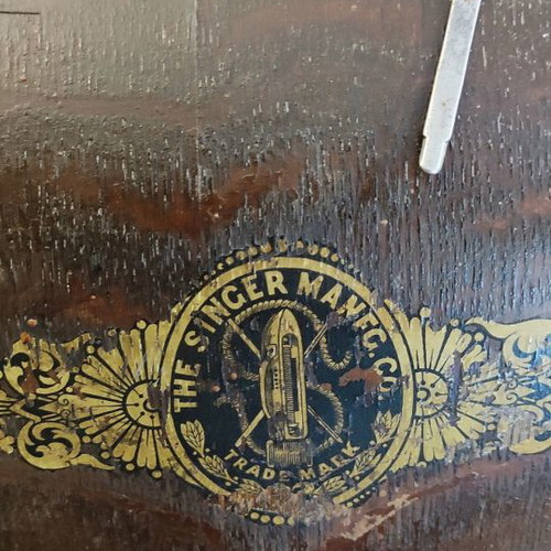 Singer sewing machine used with original wooden cover and key