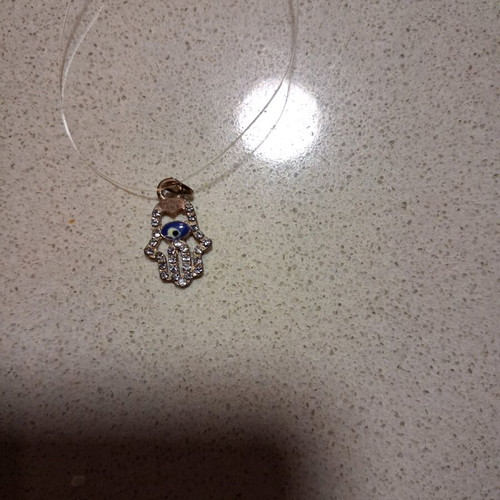 Hamsa pendant with transparent synthetic fishing line used
