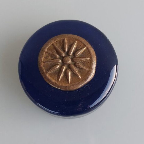 Paperweight made of blown glass with Vergina Sun bronze decoration