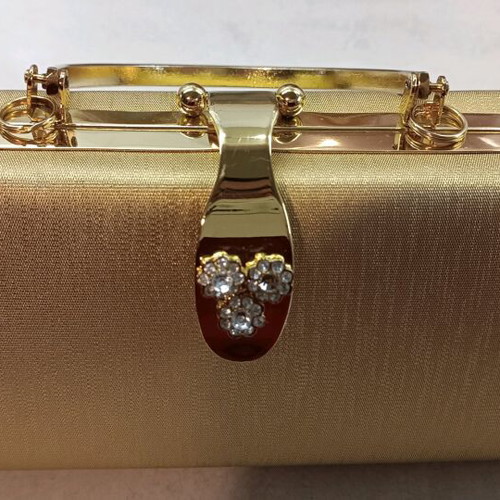 Gold evening handbag like new with missing rhinestone