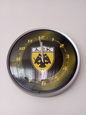 Wall clock with yellow-black team emblem
