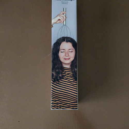 Head massager new, opened for battery placement