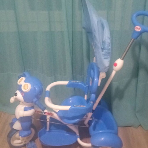 Baby blue tricycle used with canopy, storage, and adjustable parent handle