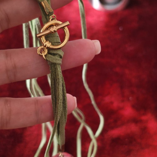 Asymmetric long necklace with green suede cord, crystal & CC motif used