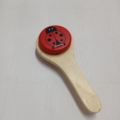 Wooden clapper used with red ladybug