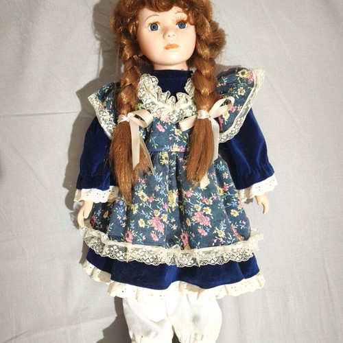 Porcelain doll with vintage dress and stand, used
