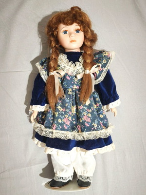 Porcelain doll with vintage dress and stand, used