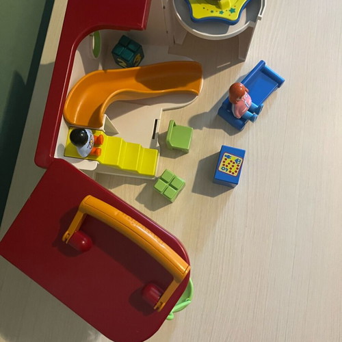 Playmobil set with three figures, slide, swing, and desk chair used