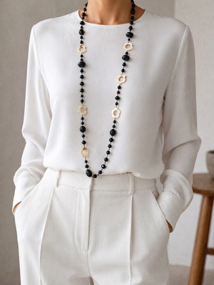 Long necklace like new with black beads and mother of pearl flower decorations
