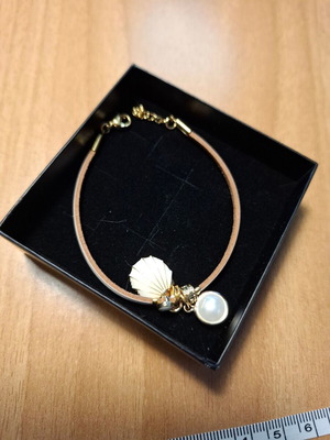 Bracelet with thin beige cord and three charms, new