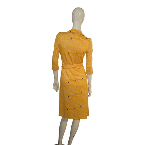 diane von furstenberg gold wrap dress When I was invited to the Diane Von Furstenberg exhibit and dinner, I  pulled out an old wrap dress only to discover that although it fit, it was  super short! Did we