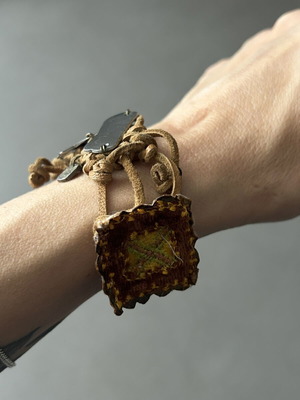 Handmade brown leather bracelet with metal charms used
