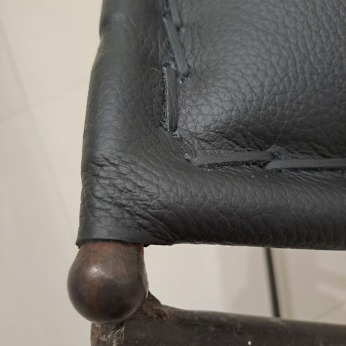 Leather footstool like new, black with cast iron frame