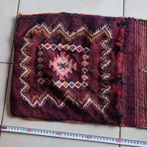 Old woven double horse saddle bag used with fabric tears