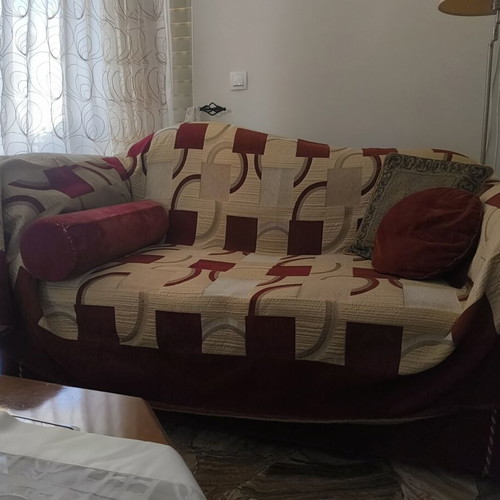Two-seater sofa used with cover and cushions