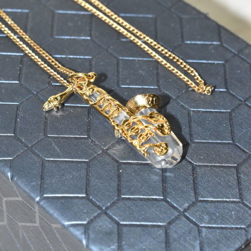 Swarovski necklace with saxophone pendant and crystal like new, gold plated