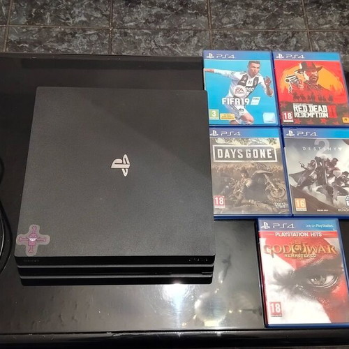 Sony PlayStation 4 Pro 1TB console with 5 games and cables