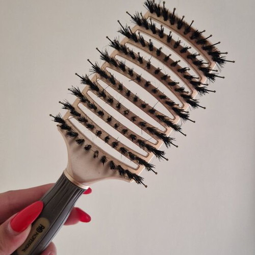 Hair comb with short bristles and openings