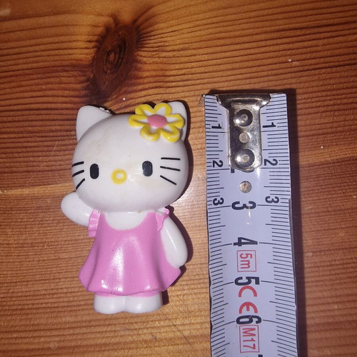 Hello Kitty figure used with pink dress and yellow flower