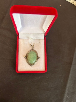 Silver pendant with green stone used