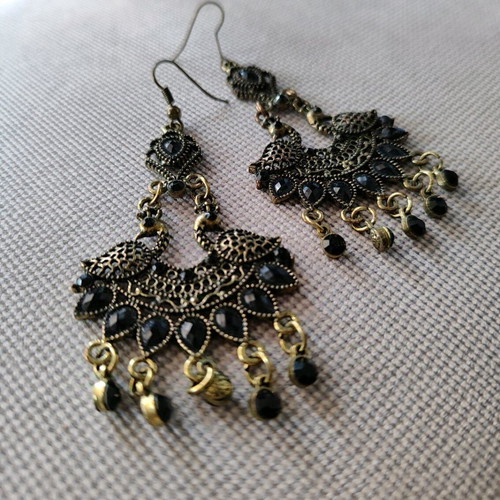 Long metal earrings used, black and gold