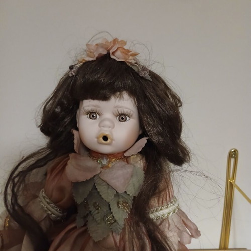 Porcelain doll sitting pose