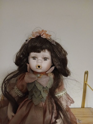 Porcelain doll sitting pose