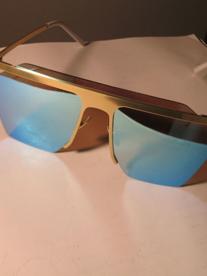Stylish women's sunglasses with blue mirrored lenses, gold frame