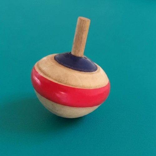 Wooden spinning top with hand-painted folk art design