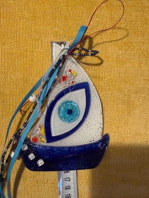 Glass sailboat wall decor like new with eye symbol