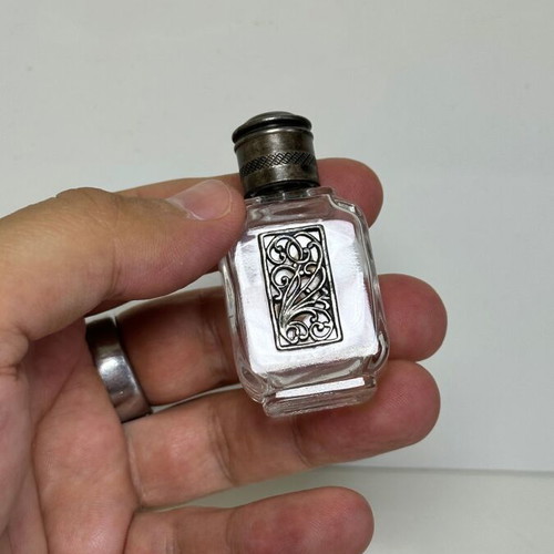 Vintage glass perfume bottle with metal decoration