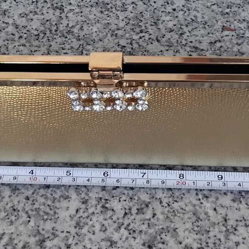 Gold evening clutch bag with rhinestones and metal frame