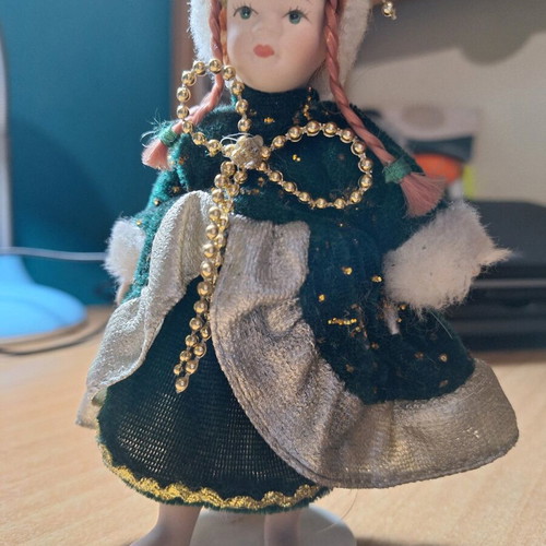 Porcelain doll on stand like new