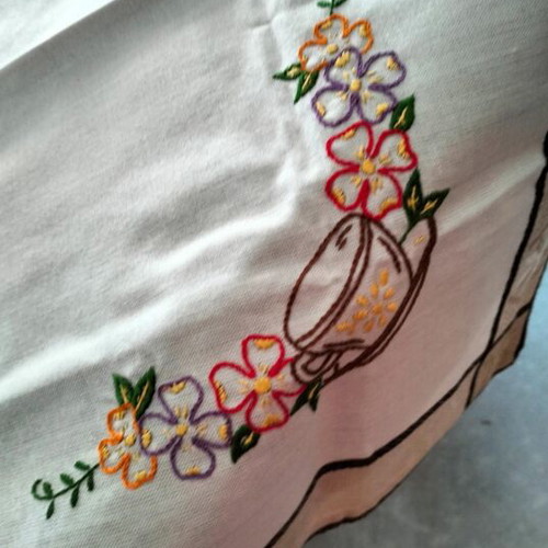 Embroidered square table linen with coffee cup and floral design