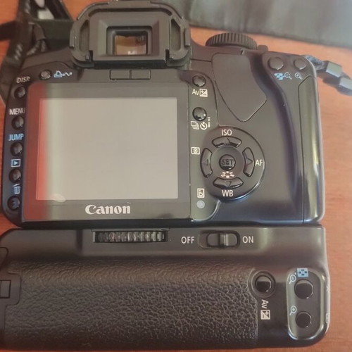 Canon EOS 400D camera used with grip, charger, and two batteries